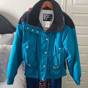 Tyrolia Puffer Ski Jacket. Size Medium. Color teal and black. Elastic at waist.